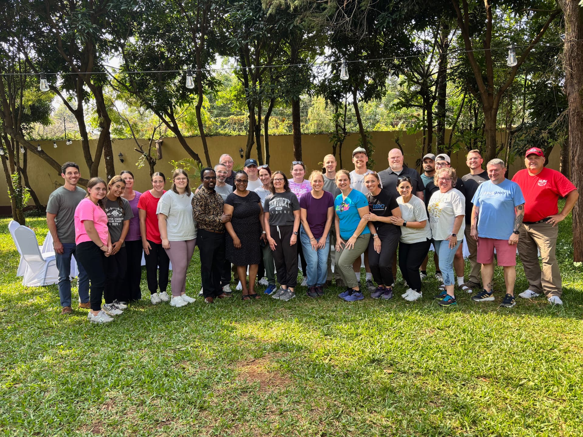 The full mission team posing together under trees in Nairobi
