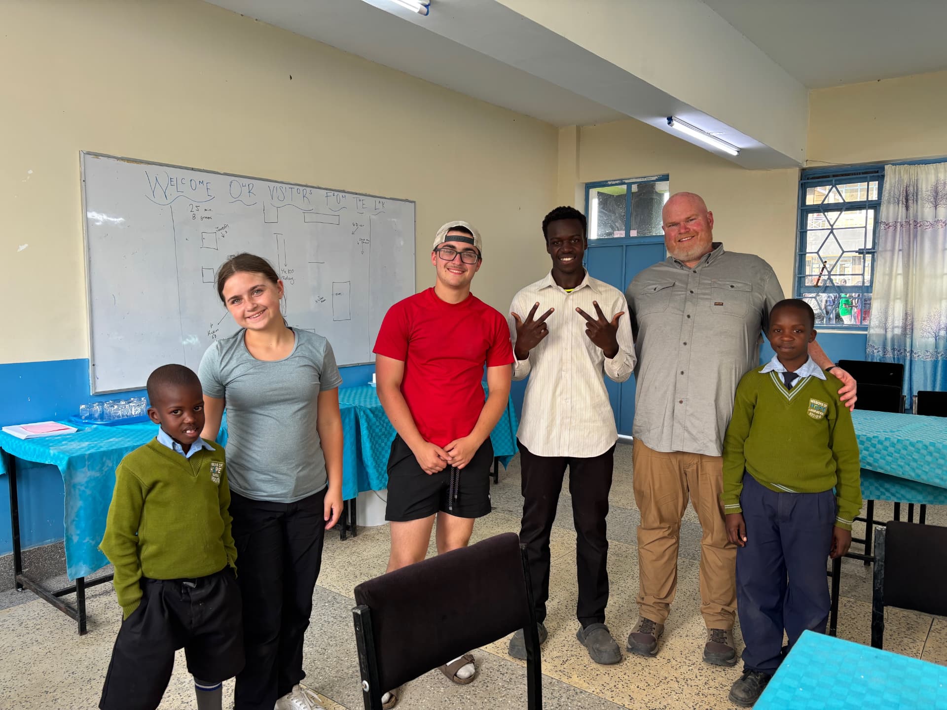Travis with students in a Ndovoini classroom